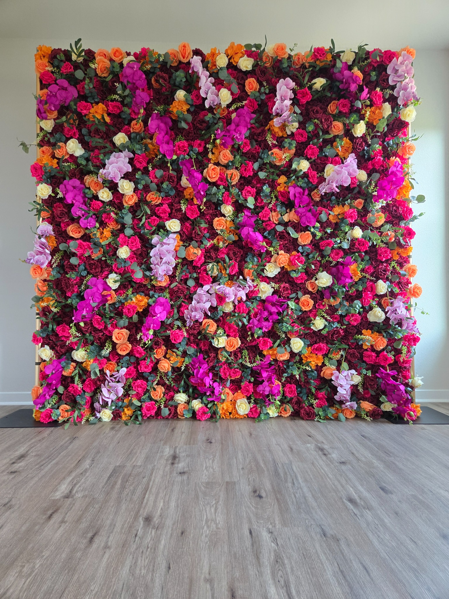 The Carmen jewel-toned flower wall