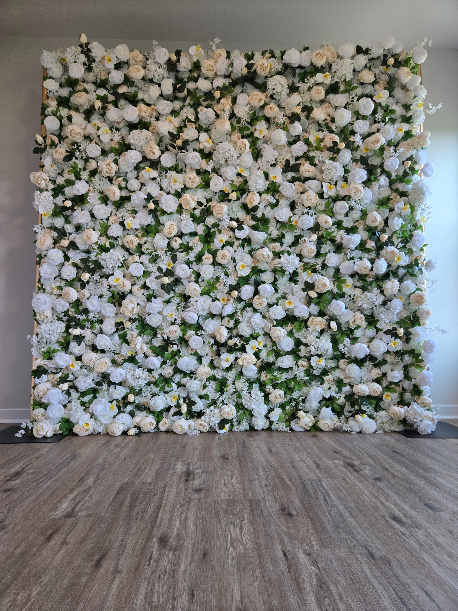 The Charlotte white flower wall with greenery